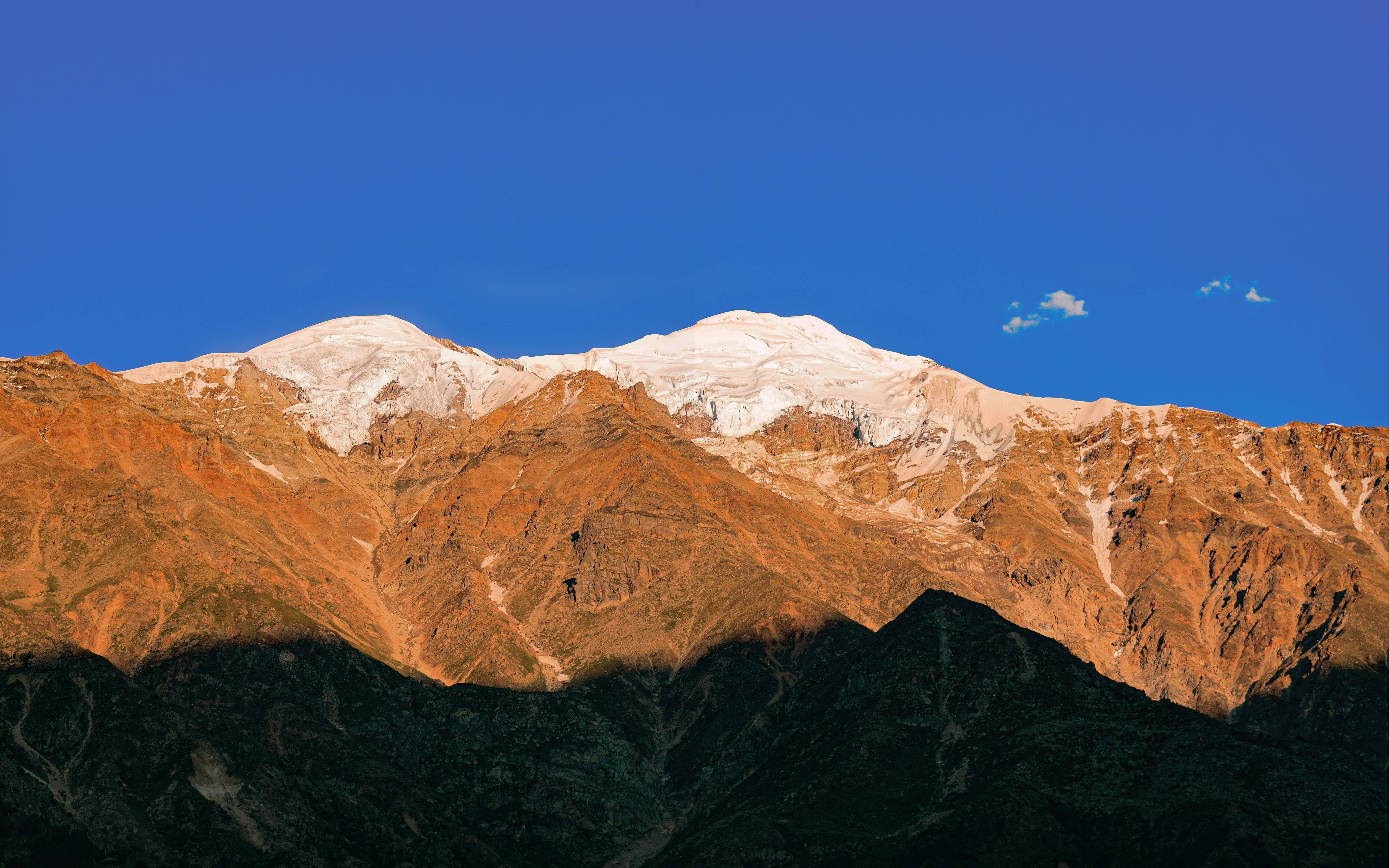 a view of a mountain range with a cloud in the sky
