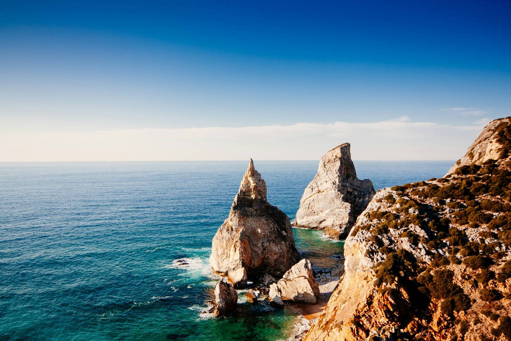 rock formations on sea at daytime