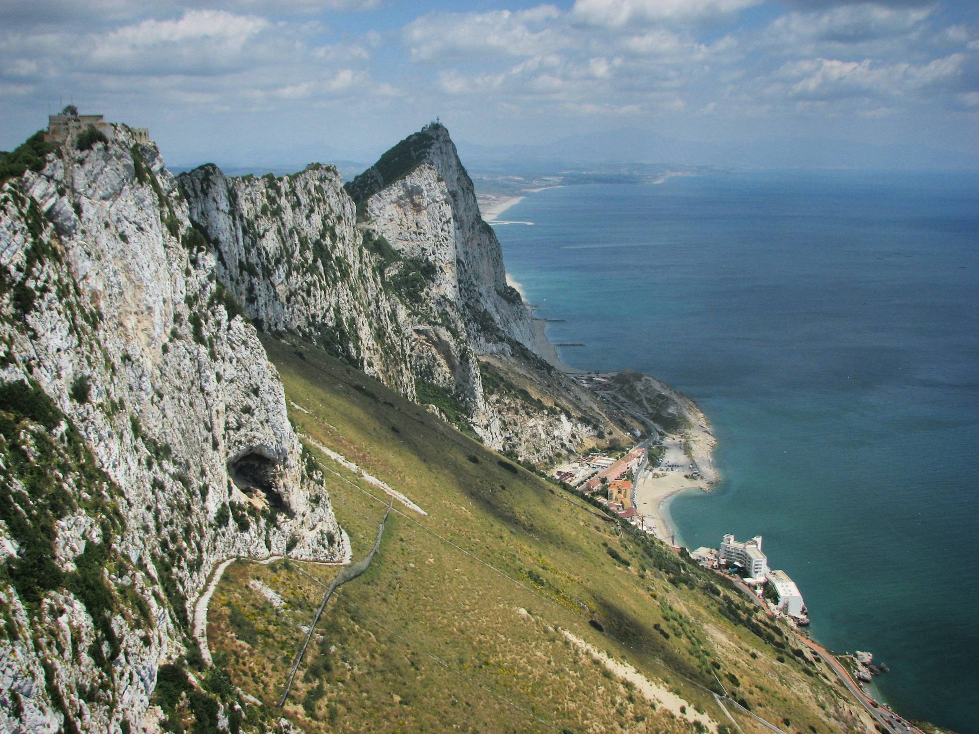 a view of a mountain with a body of water in the background