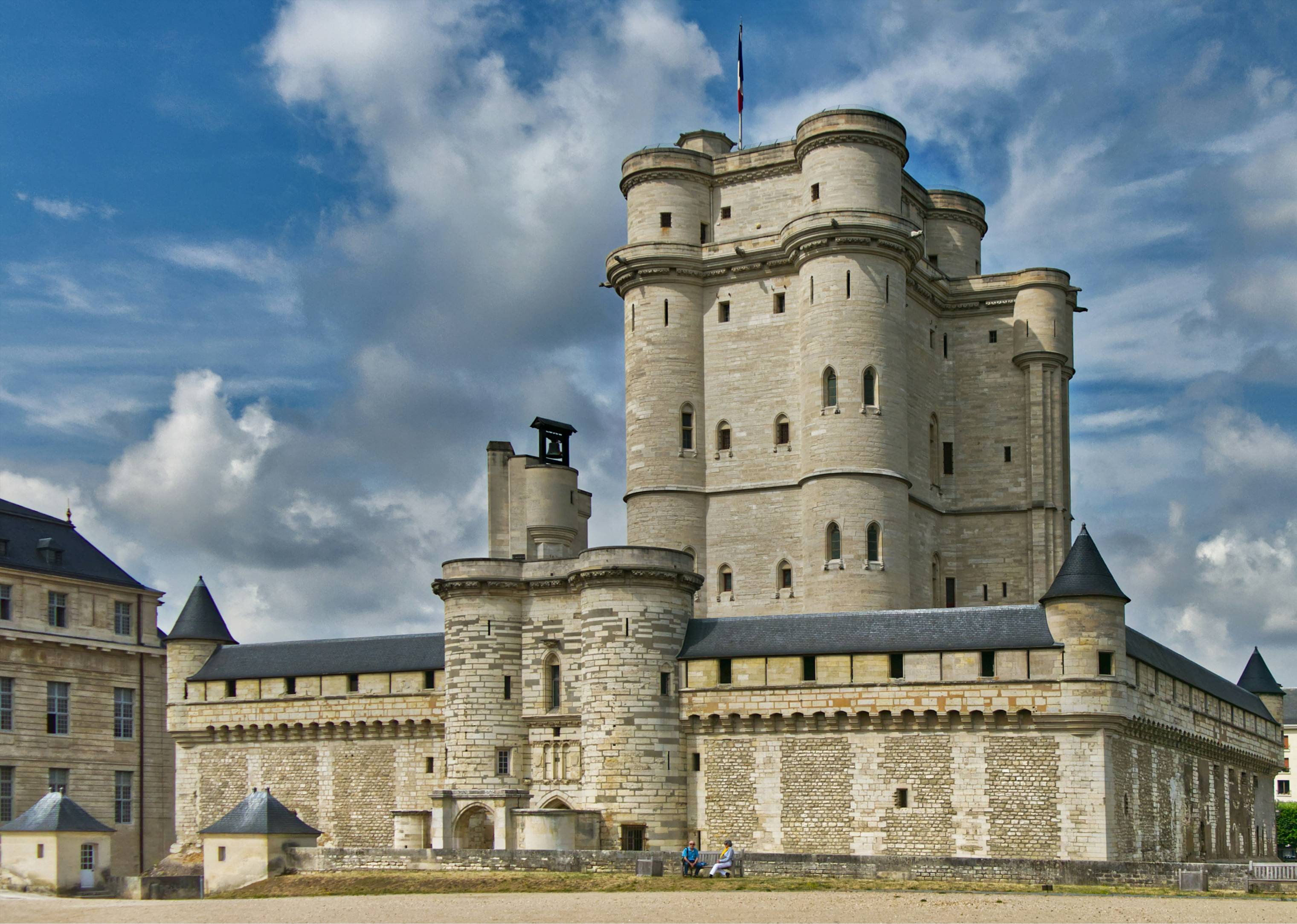 a large castle like building with a flag on top of it